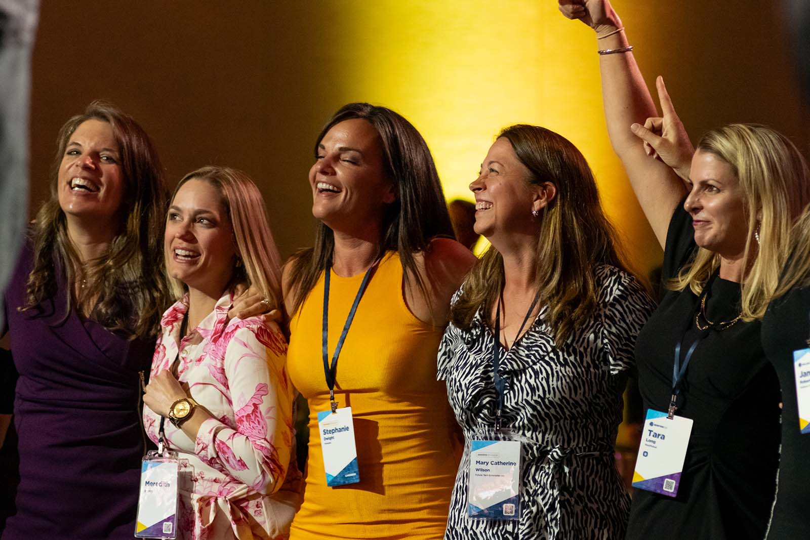 female participants in the Converge national member conference linked arm in arm